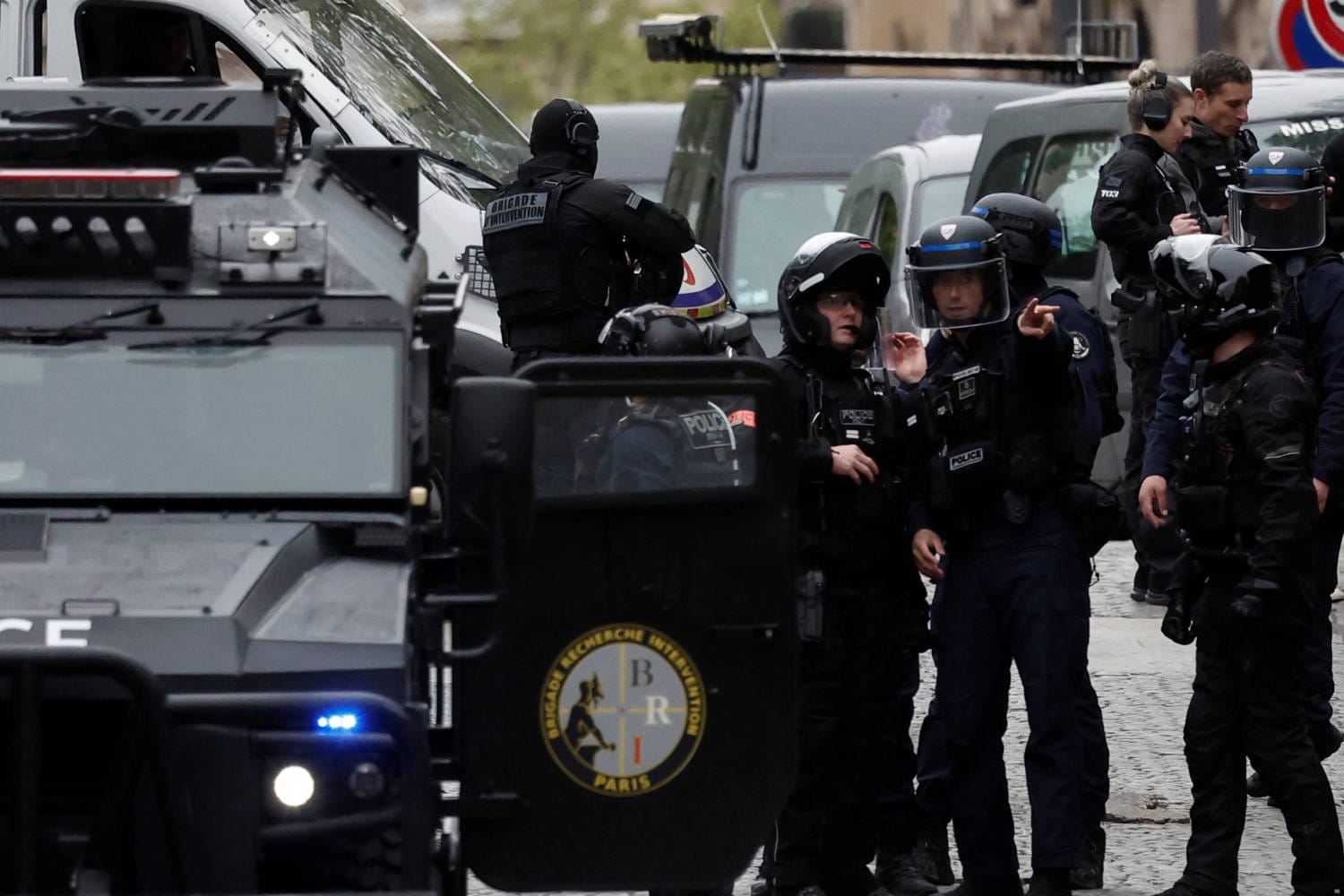 French police cordoned off the Iranian consulate in Paris after a man carrying a grenade and explosive vest threatened to blow himself up inside